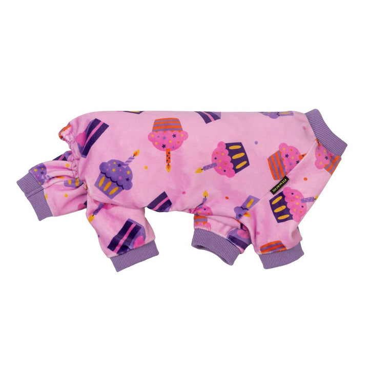 Side view of birthday dog onesie with cake prints on a white background