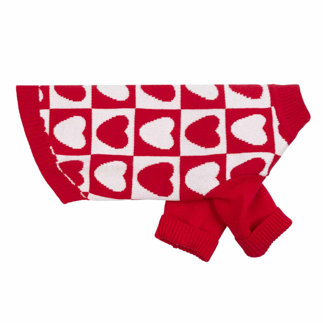 Red and white heart knit dog sweater laid flat, showcasing checkered pattern and sleeve detail