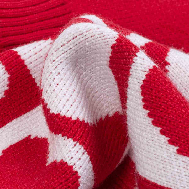 Close up of red and white heart pattern knitted fabric on dog sweater texture