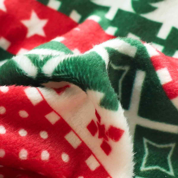 Christmas dog pajama fabric detail: red and green festive patterns, soft velvet material