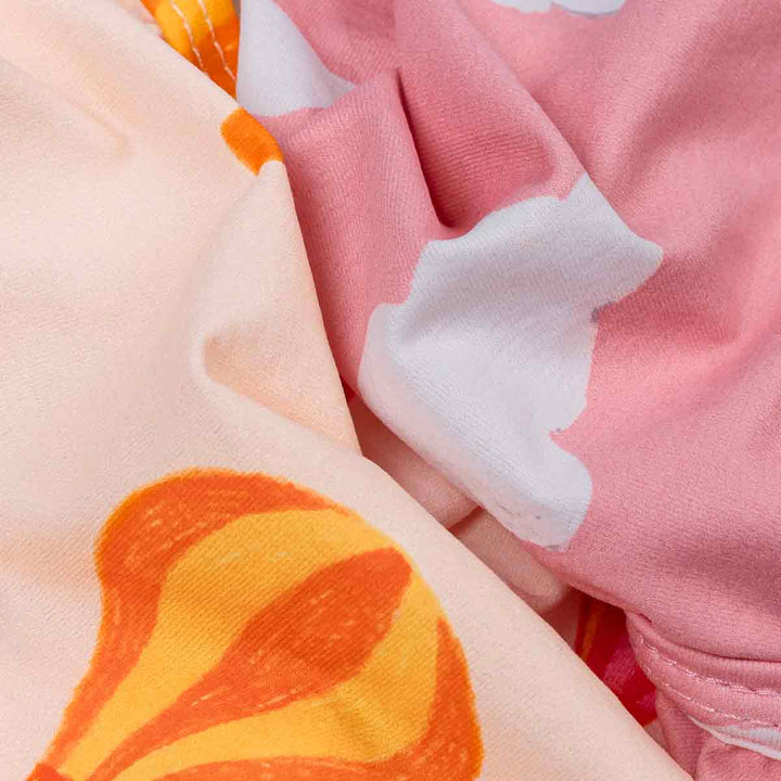 Close-up of fabric with orange, pink, and white patterns