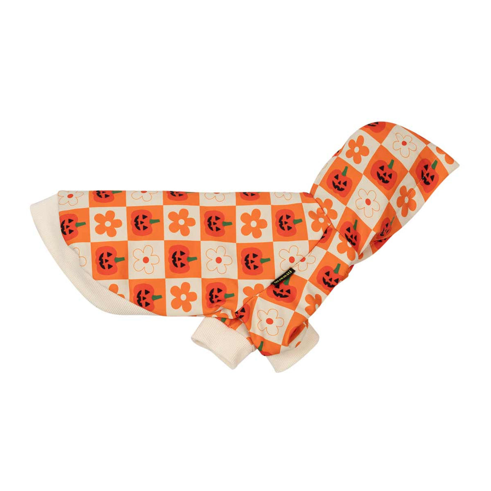 Side view of dog hooded sweatshirt with a Halloween-themed pattern of orange pumpkins and flowers on a white and orange checkered background