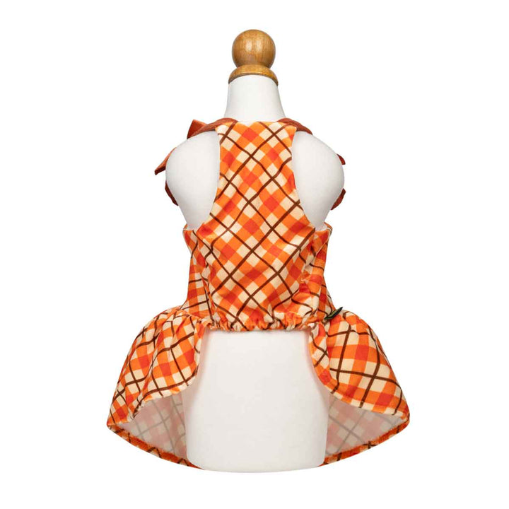 Sleeveless orange plaid dog dress displayed on a white mannequin torso with a wooden finial, shown from the back against a plain white background
