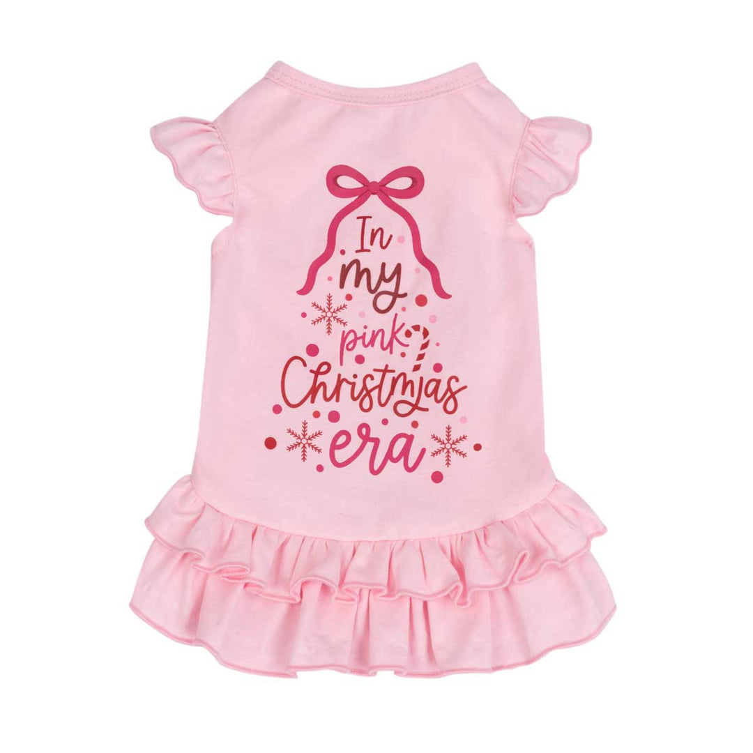 Pink dog dress with ruffled sleeves and a ruffled hem, featuring a Christmas-themed graphic on the back that reads 'In my pink Christmas era' with a bow and snowflake details