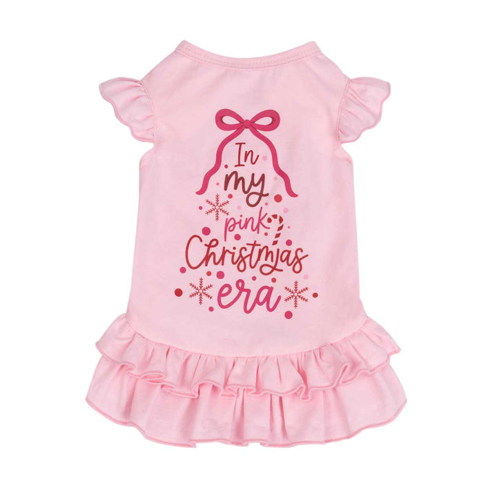 Pink dog dress with ruffled sleeves and a ruffled hem, featuring a Christmas-themed graphic on the back that reads 'In my pink Christmas era' with a bow and snowflake details