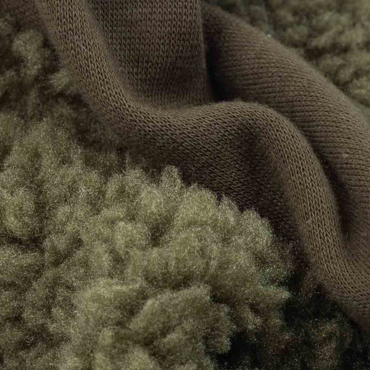 Close-up of olive green sherpa and knit fabric texture used in dog sweater.