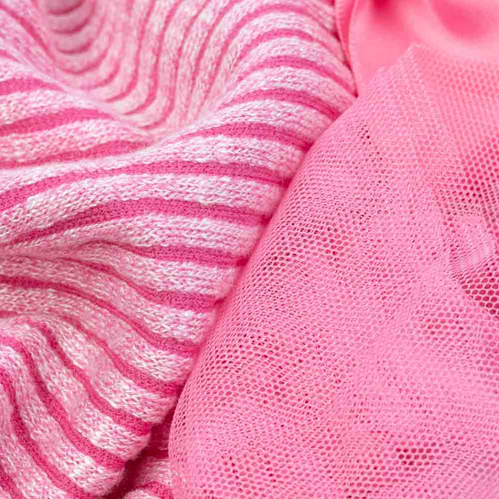 Pink and white striped knitted fabric next to sheer pink tulle fabric.