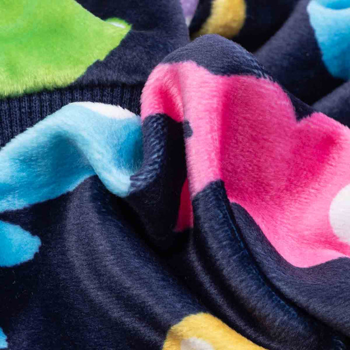 Close up of lightweight velvet dog pajamas fabric with colorful bunny shapes.