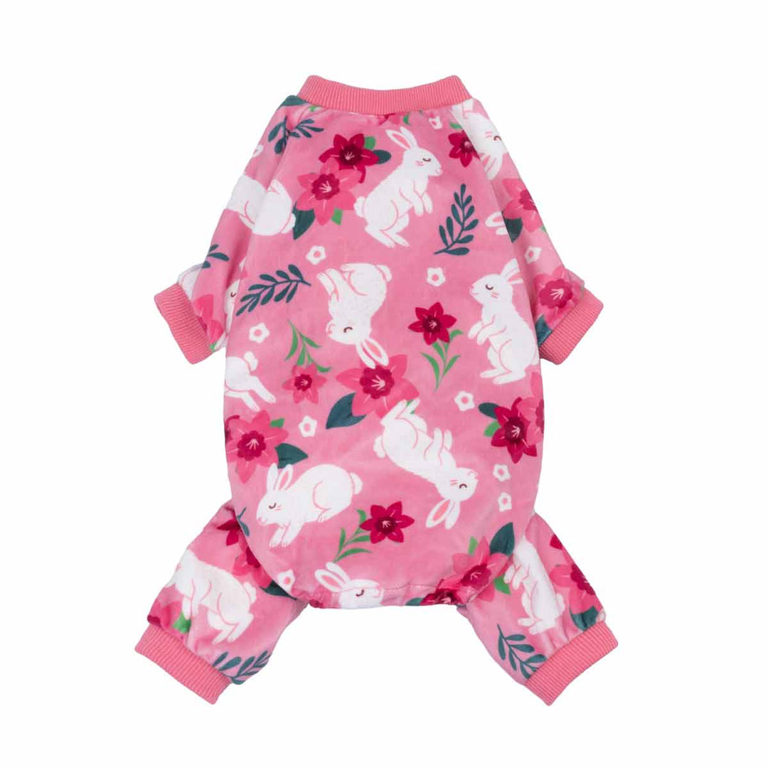 Pink dog pajamas featuring white bunnies and floral accents on a soft all-over print