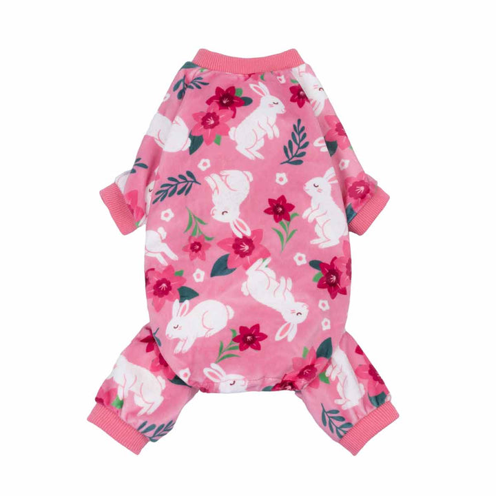 Pink dog pajamas featuring white bunnies and floral accents on a soft all-over print