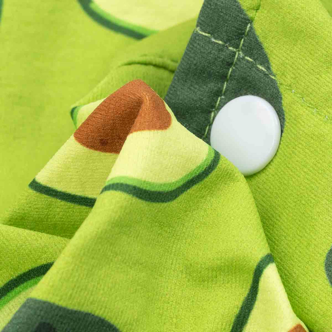 Close-up of avocado print dog shirt fabric with button and detailed stitching