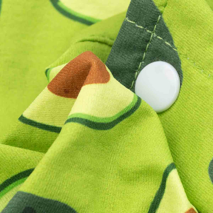Close-up of avocado print dog shirt fabric with button and detailed stitching