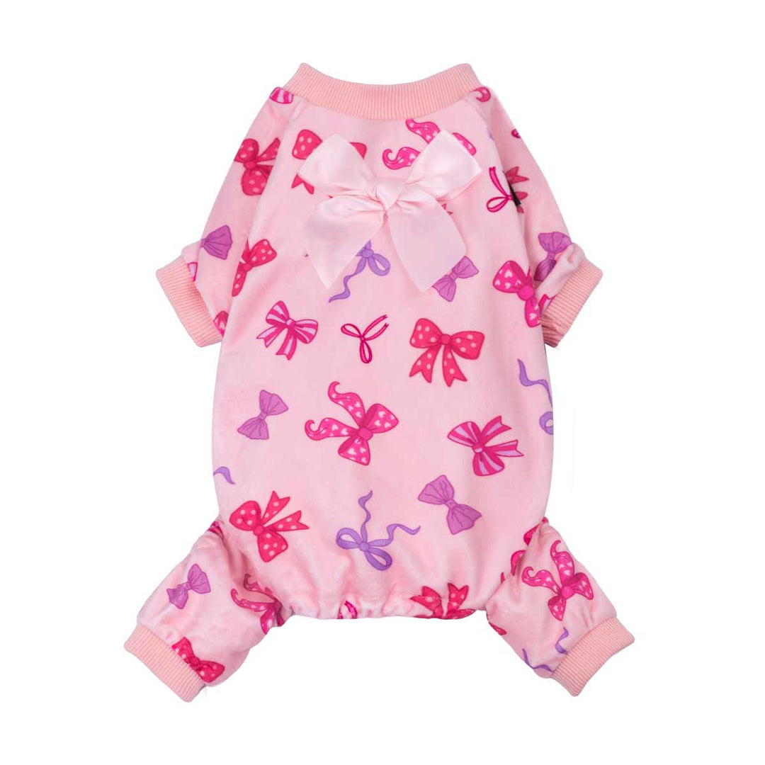 Pink dog pajamas featuring an allover bow pattern with a large satin bow detail on the back.