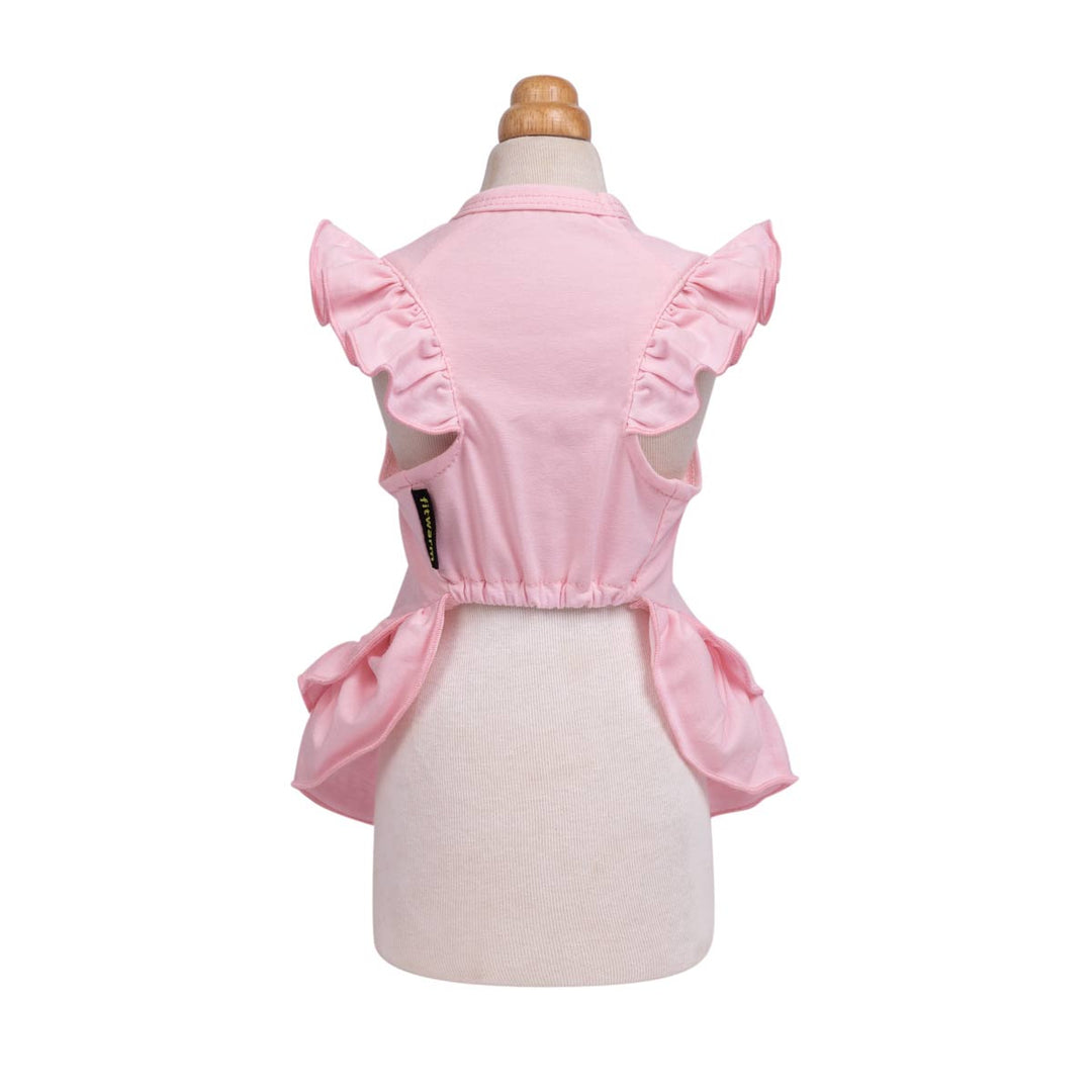 Pink sleeveless dog Christmas dress with ruffled shoulder details and a gathered waist, displayed on a cream dress form against a white background