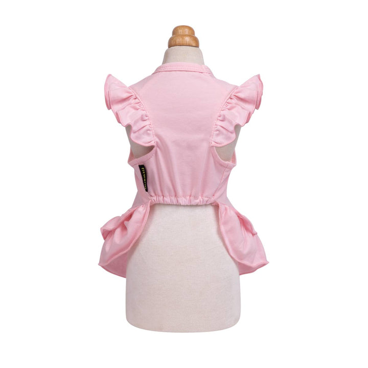 Pink sleeveless dog Christmas dress with ruffled shoulder details and a gathered waist, displayed on a cream dress form against a white background