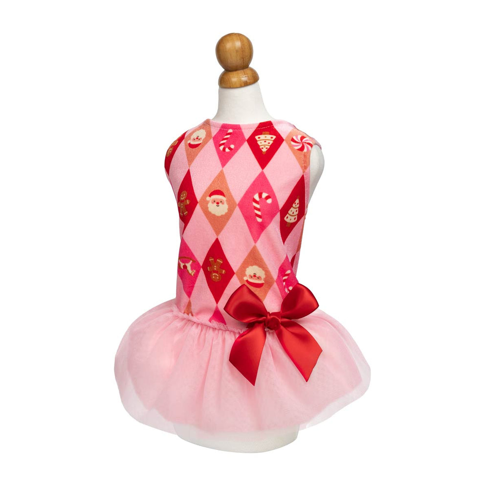 Festive sleeveless dress for dogs displayed on a mannequin against a white background feacturing a pink and red argyle pattern on the top with holiday-themed motifs like Santa Claus, candy canes, and gingerbread cookies