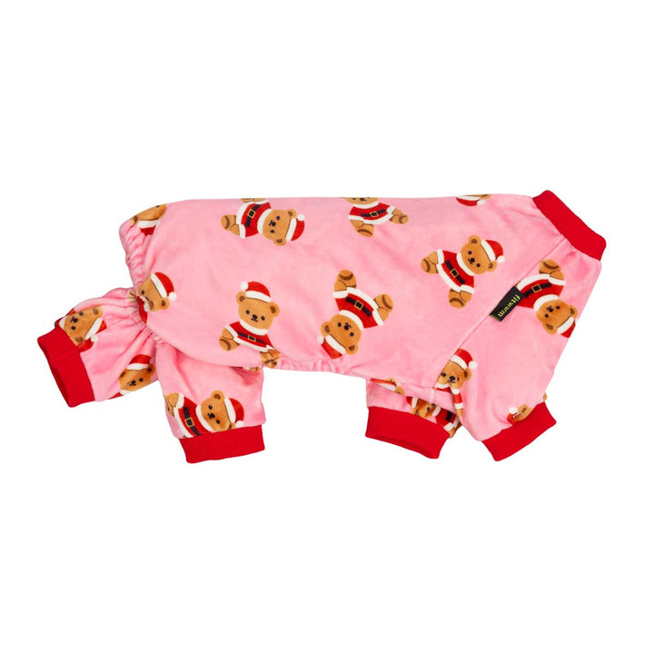 Pink dog onesie featuring a repeating pattern of teddy bears in Santa Claus outfits, with red cuffs and collar, shown on a plain white background
