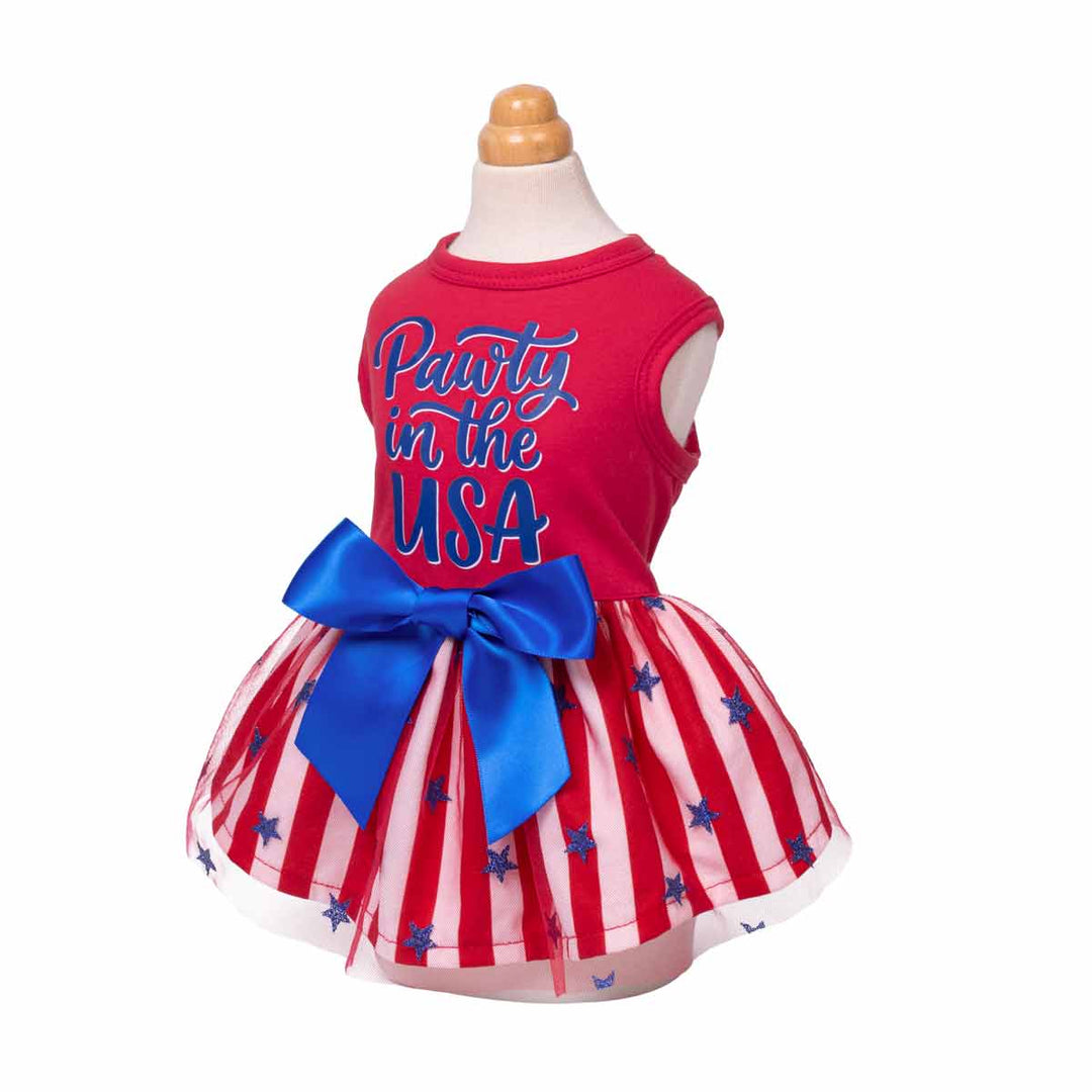 4th of July dress for dogs with blue bow and 'Pawty in the USA' lettering on a mannequin against a white background
