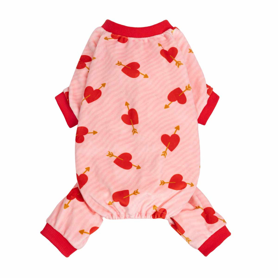 Pink dog pjs with red heart and arrow pattern, red collar and cuffs, shown on a plain white background