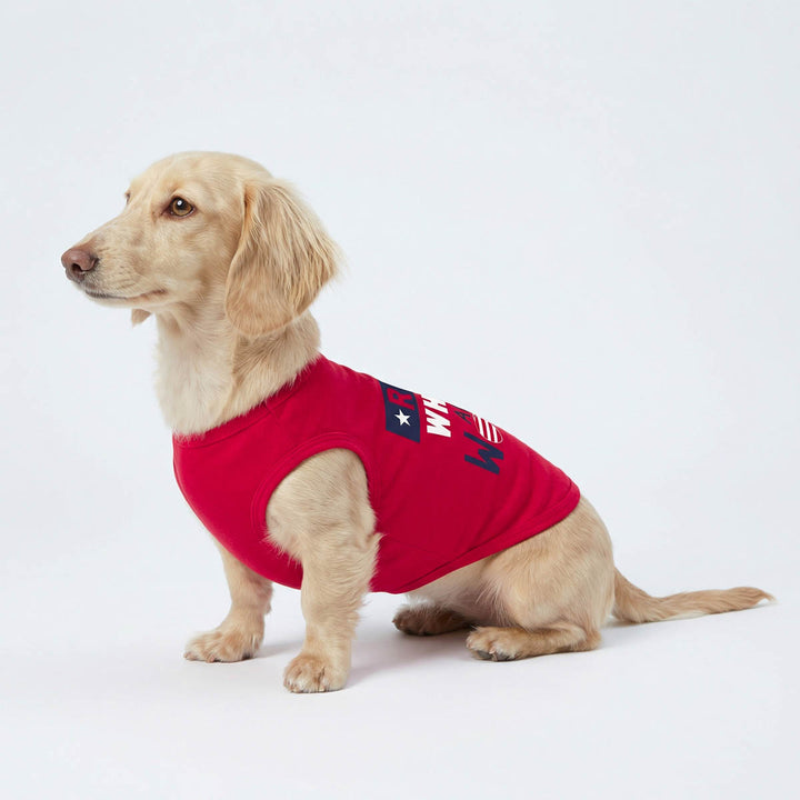 Dachshund wearing a red 4th of July shirt for dogs with text on a white background