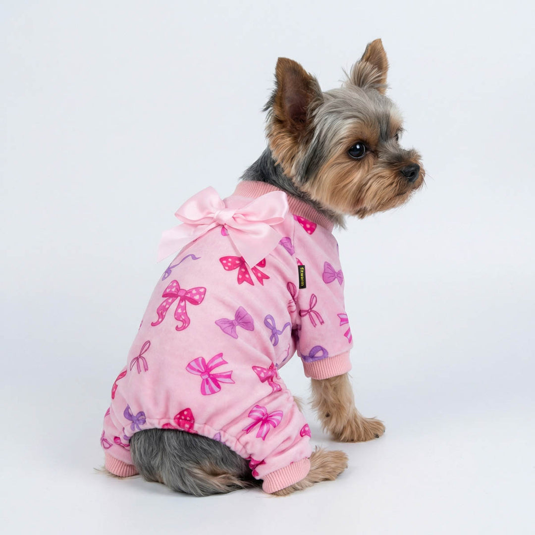 Small dog wearing pink bowknot dog onesie with Valentine themed prints
