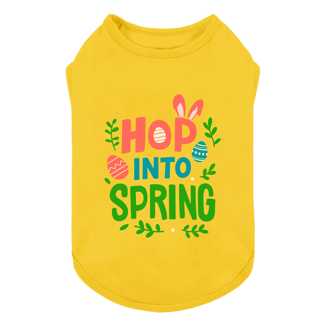 Bright yellow Easter dog shirt featuring “Hop Into Spring” text with bunny ears and colorful egg graphics