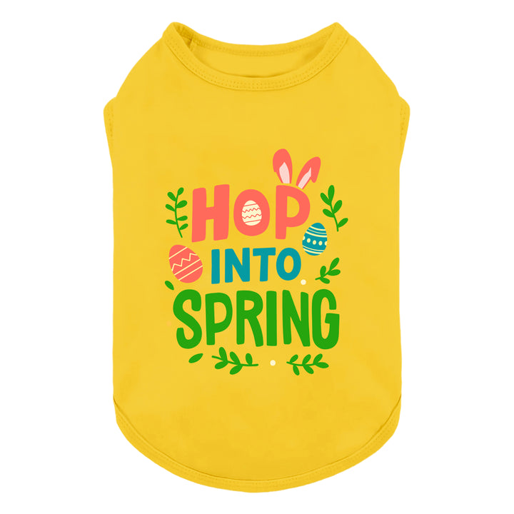 Bright yellow Easter dog shirt featuring “Hop Into Spring” text with bunny ears and colorful egg graphics