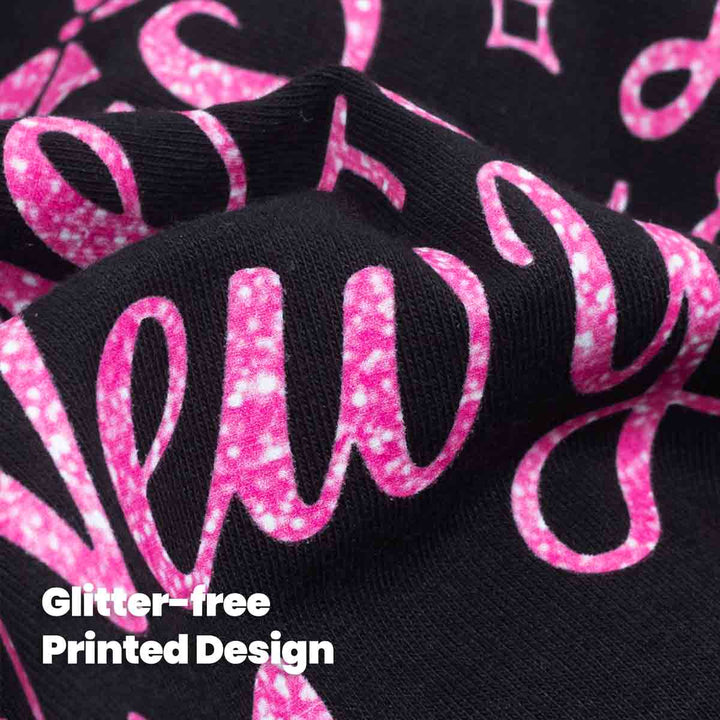 Close-up of glitter-free printed pink design on black dog shirt fabric.