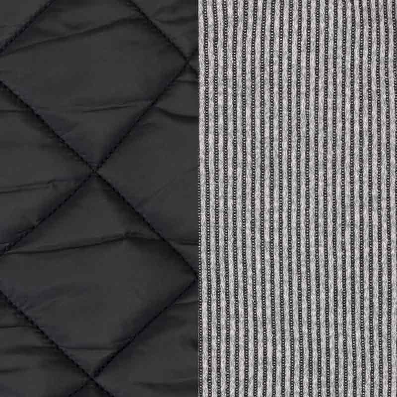 Dog coat material comparison with black quilted padded fabric on one side and gray striped knit on the other.