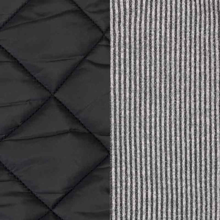 Dog coat material comparison with black quilted padded fabric on one side and gray striped knit on the other.