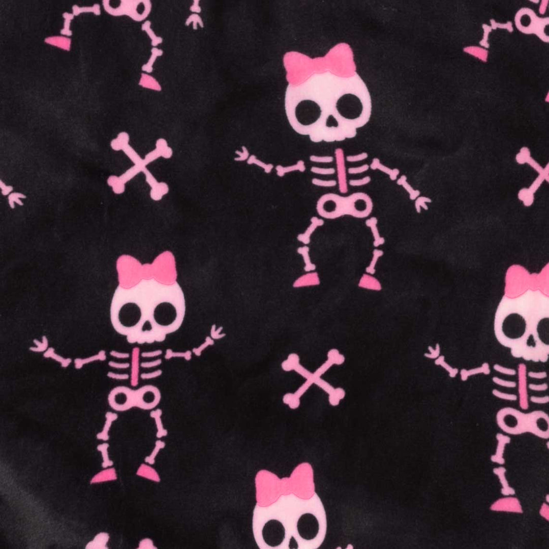 Black fabric with a repeating pattern of pink cartoon skeletons wearing pink bows