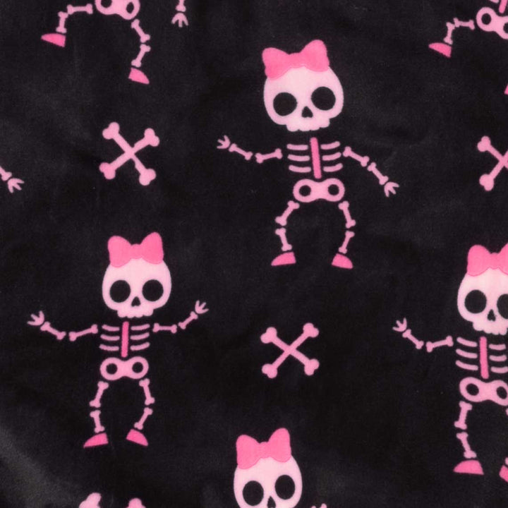 Black fabric with a repeating pattern of pink cartoon skeletons wearing pink bows