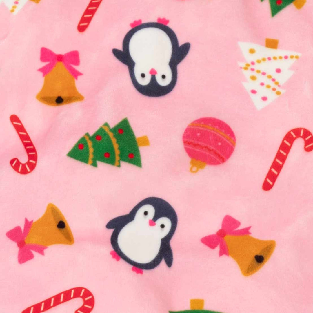 Pink fleece fabric with a festive Christmas pattern featuring penguins, bells, candy canes, ornaments, and Christmas trees