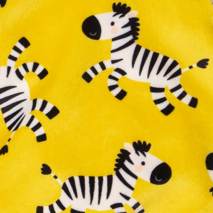 Yellow dog pajamas fabric with repeating cartoon zebra pattern in close-up view.
