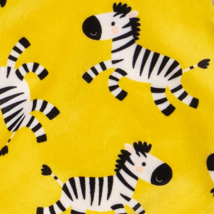 Yellow dog pajamas fabric with repeating cartoon zebra pattern in close-up view.