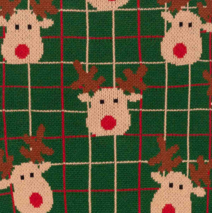 Close-up of a knitted fabric featuring a festive Christmas pattern with reindeer faces and a green plaid grid