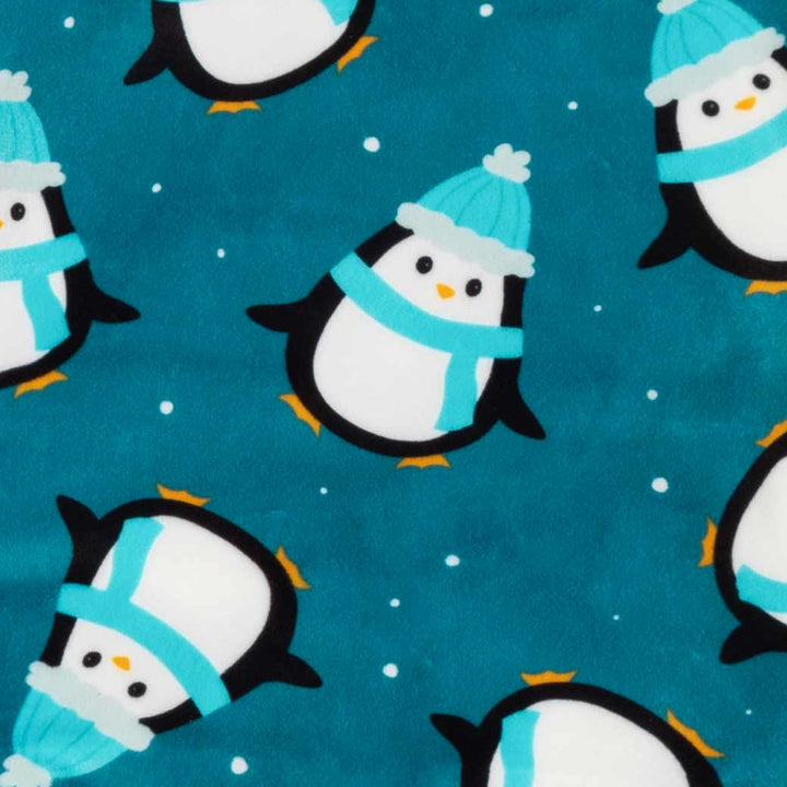 Teal blue penguin dog pajamas fabric detail. Soft fleece with penguin print, perfect for small dog comfort