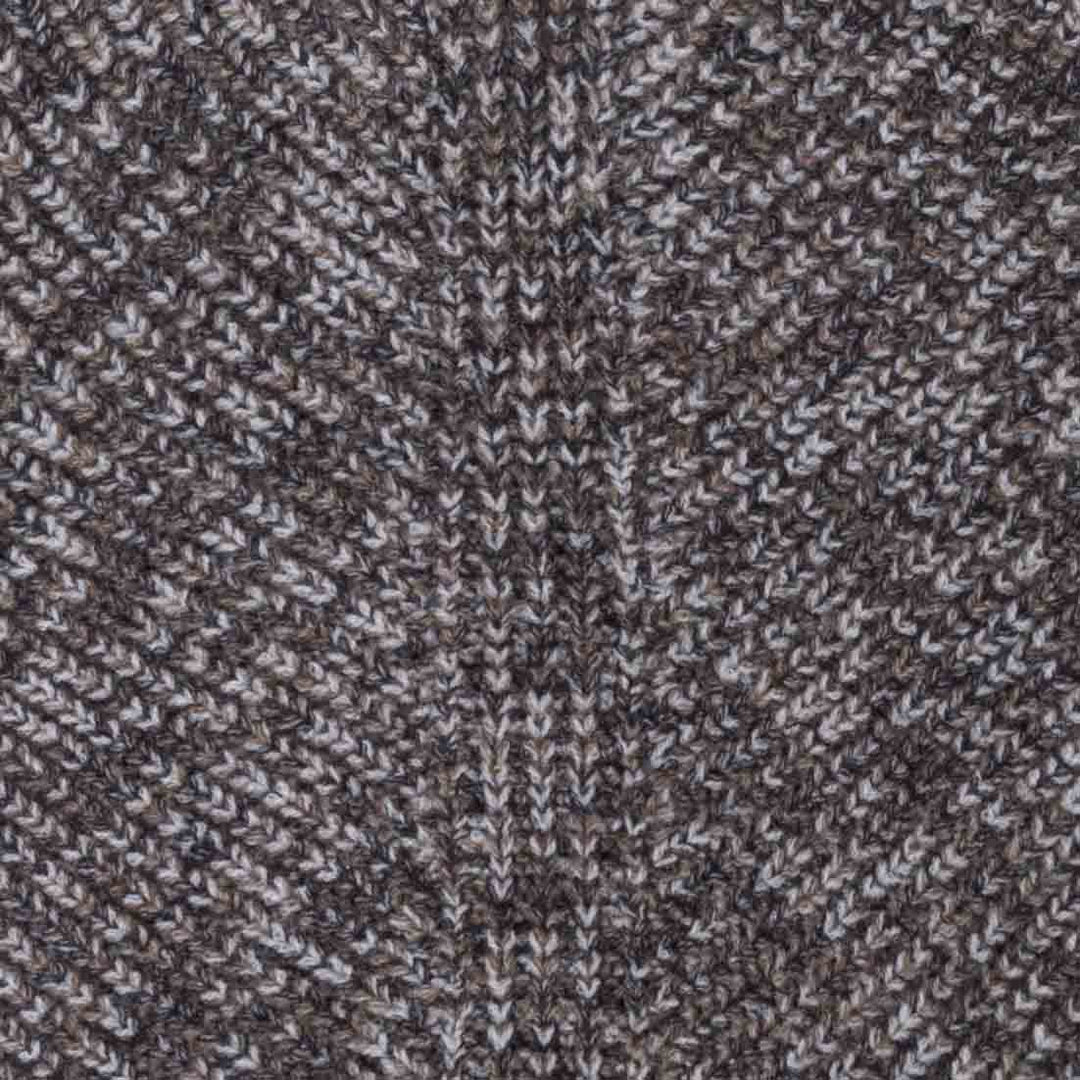 Close up of the fabric on dog winter sweater in a brown and white heathered knit pattern