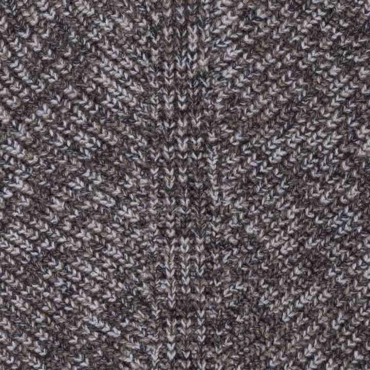 Close up of the fabric on dog winter sweater in a brown and white heathered knit pattern