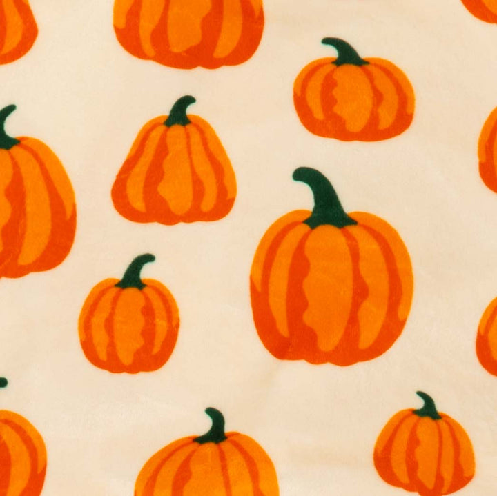 Cozy dog pajamas with allover orange pumpkin print and green cuffs