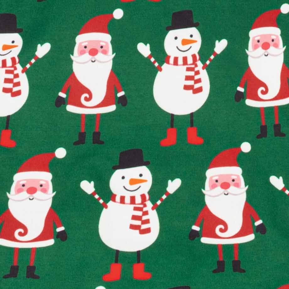 Close-up of a green fabric featuring a repeating pattern of cartoon Christmas Santa Claus and snowman figures in red, white, black, and orange