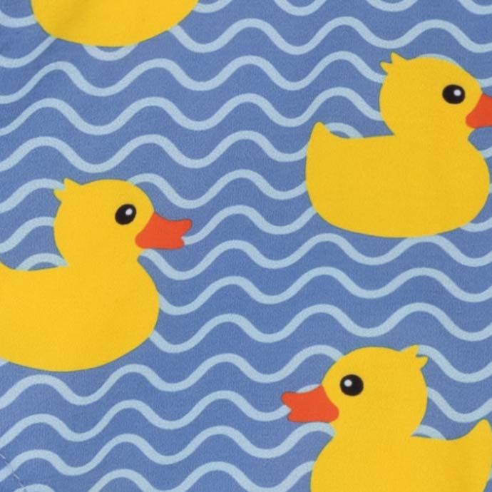Summer dog shirt fabric with playful yellow ducks and blue wave print.