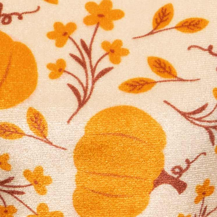 Dog dress with cozy pumpkin and floral prints in warm yellow tones, adding a festive fall charm.