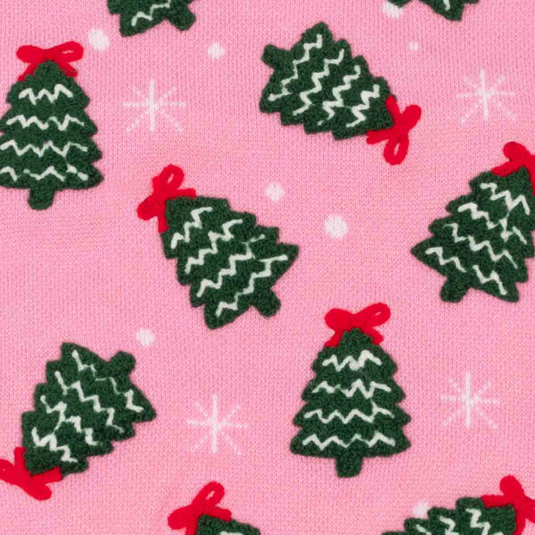 Close up of pink fabric with Christmas tree and snowflake