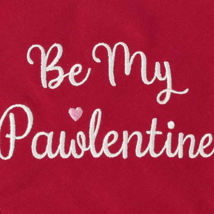 Cotton blend red dog bandanas fabric texture close up with embroidery detail.