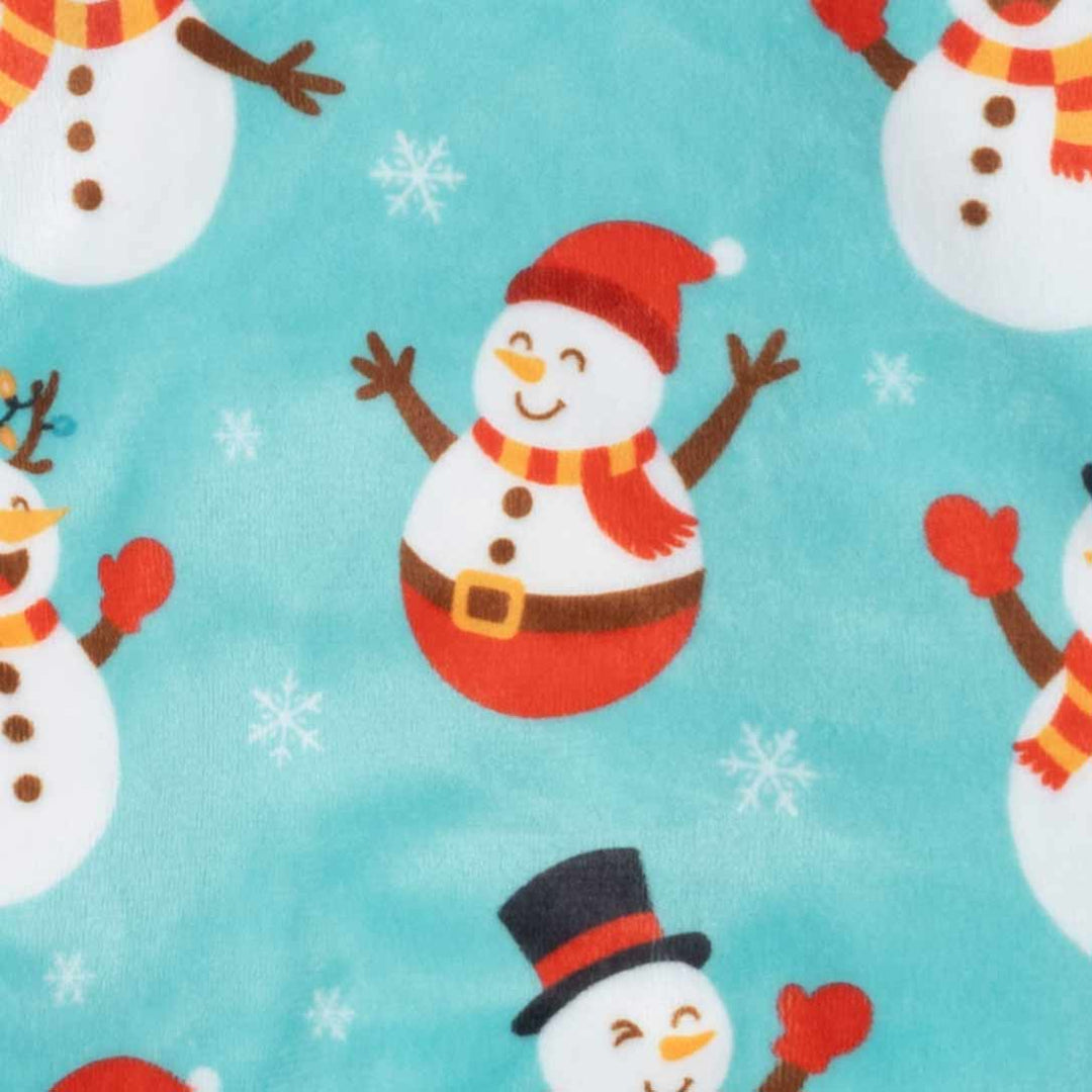 Close-up of dog pajamas snowman pattern on light-blue fabric with small snowflakes.