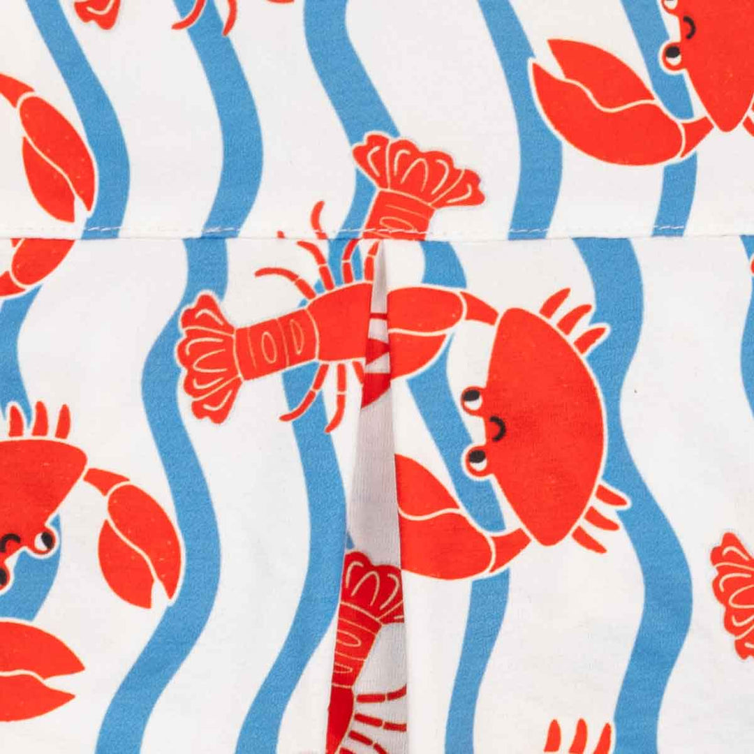 Pattern of red crabs and blue wavy lines on a white background