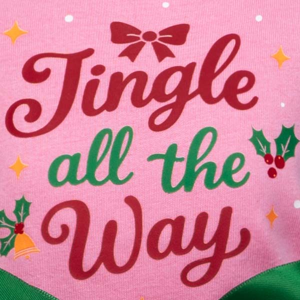 Detail shot of dog dress print with festive holiday message in red and green.