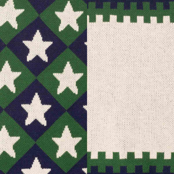 Close-up of a knitted textile pattern split vertically: the left half shows green and navy diamonds with white stars, and the right half shows a green and navy color block pattern