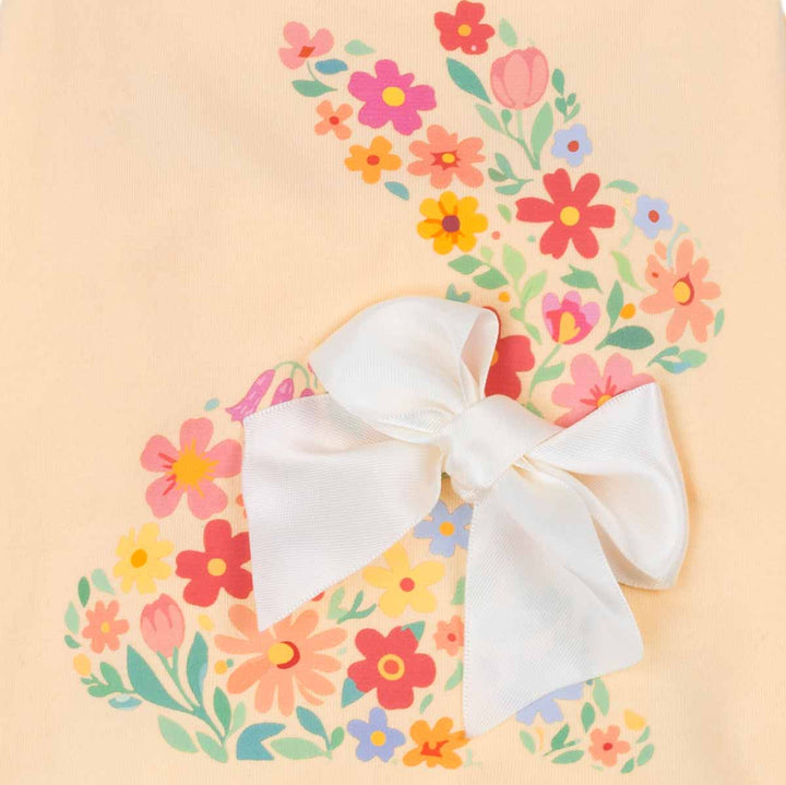 Dog shirt detail with floral bunny graphic and oversized white bow